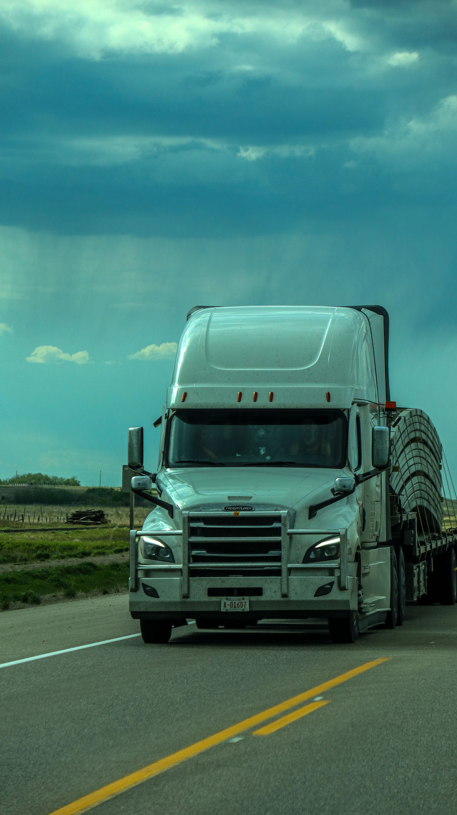 Semi-truck under a dramatic sky